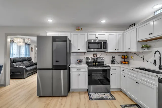 a kitchen with stainless steel appliances a refrigerator sink and cabinets