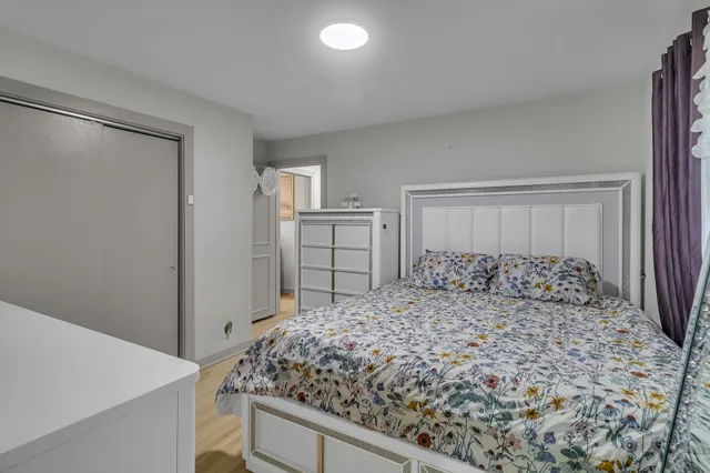 a bedroom with a large bed and a dresser