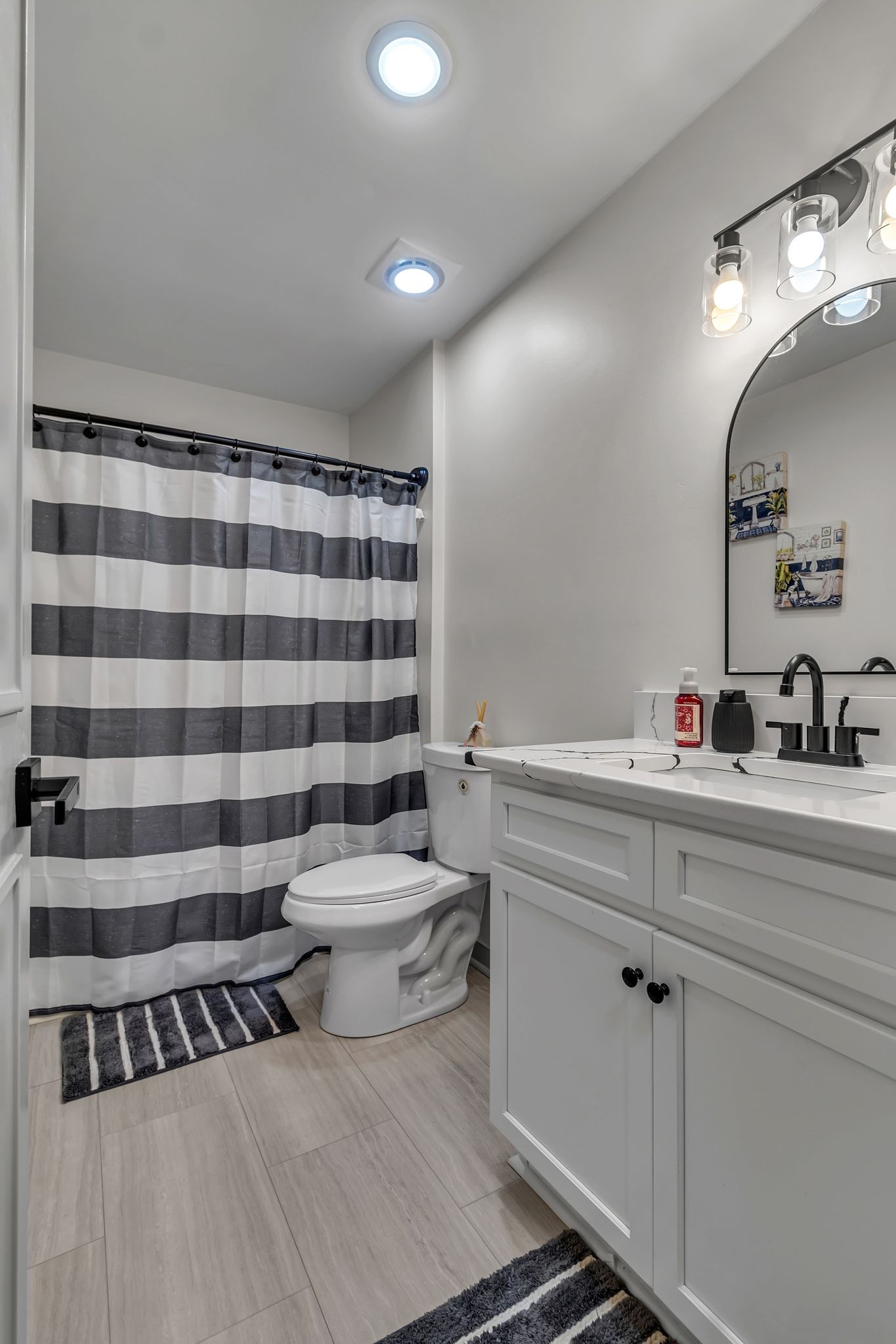 3759 Snell Road Murfreesboro, TN 37127 - Photo 22 of 27 a bathroom with a sink a toilet a large mirror and shower curtain