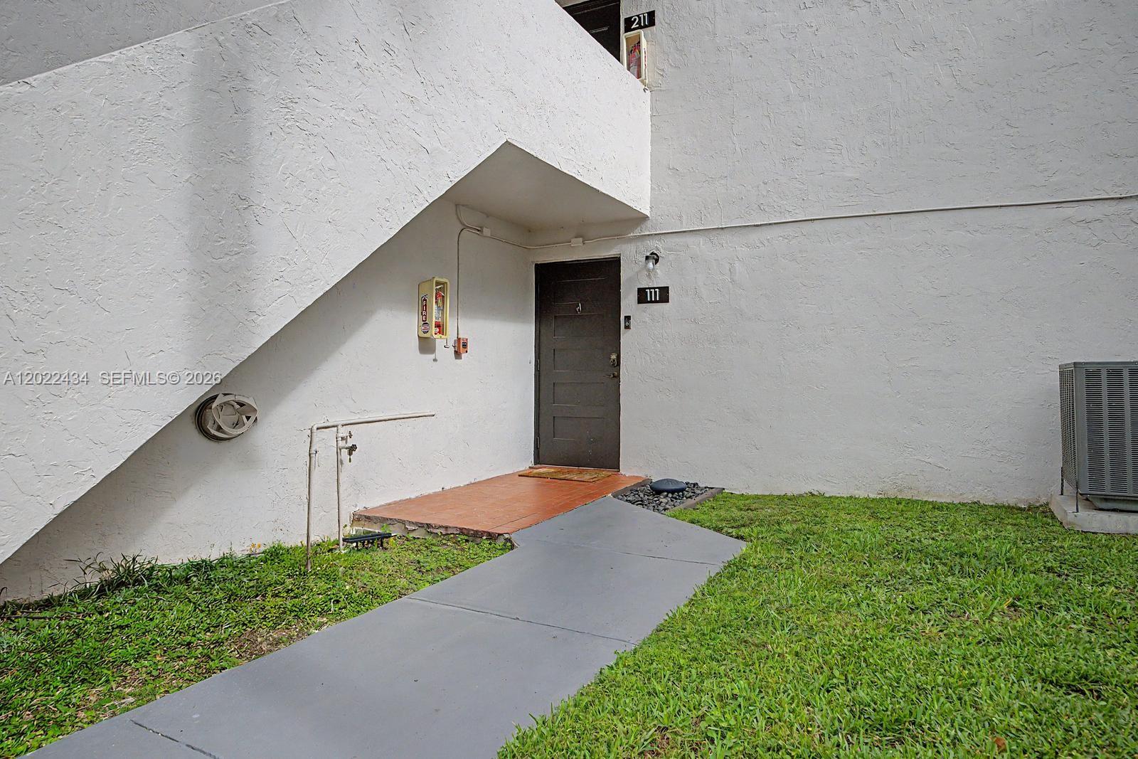 13045 Southwest 68th Street, Unit 111 Miami, FL 33183 - Photo 1 of 15 a backyard of a house with lots of green space