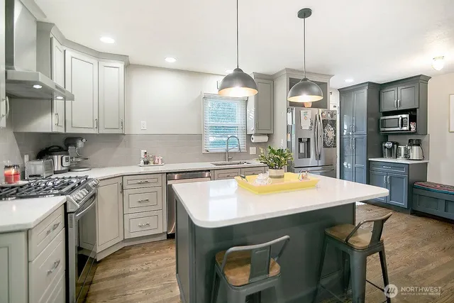 a kitchen with a sink a stove a refrigerator and cabinets