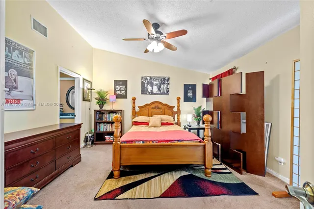 a bedroom with a bed and a dresser in it