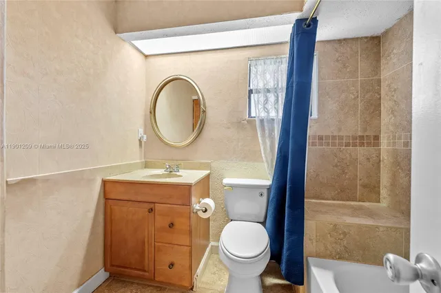 a bathroom with a toilet a sink and mirror