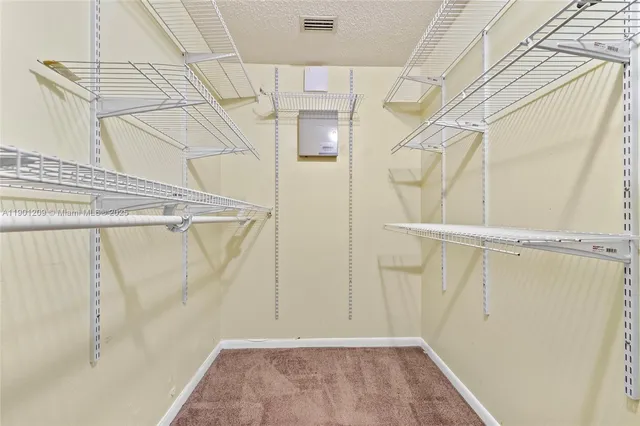 a view of walk in closet with white walls