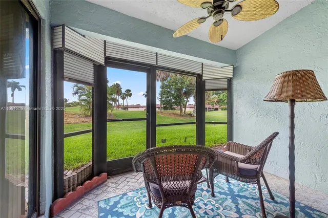 a view of a porch with furniture and a yard