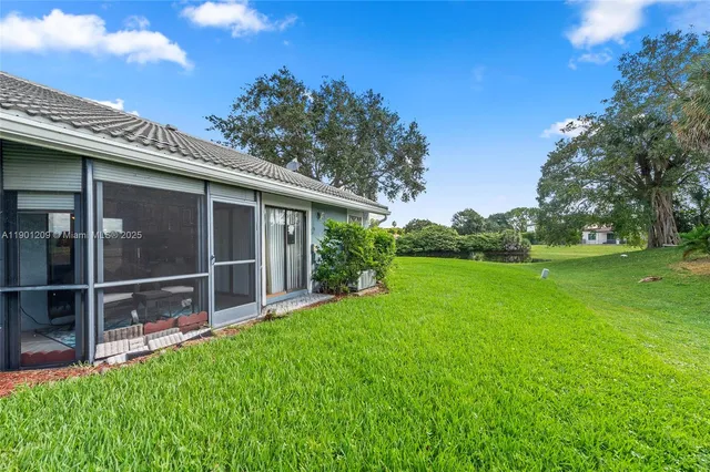 a view of an house with backyard space and garden view