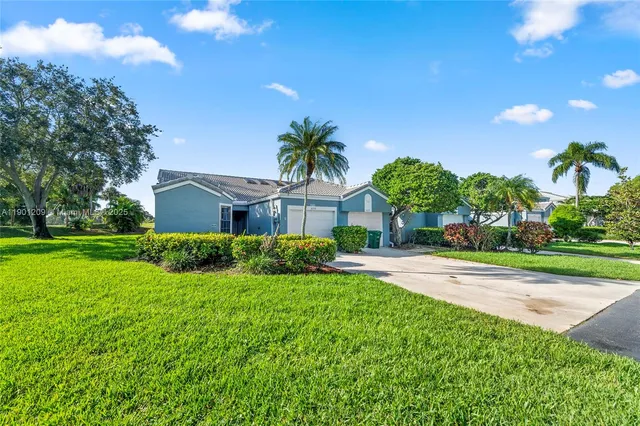 a front view of house with yard and green space