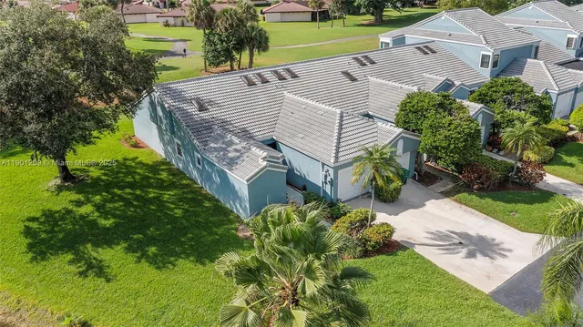 an aerial view of a house with a yard and potted plants