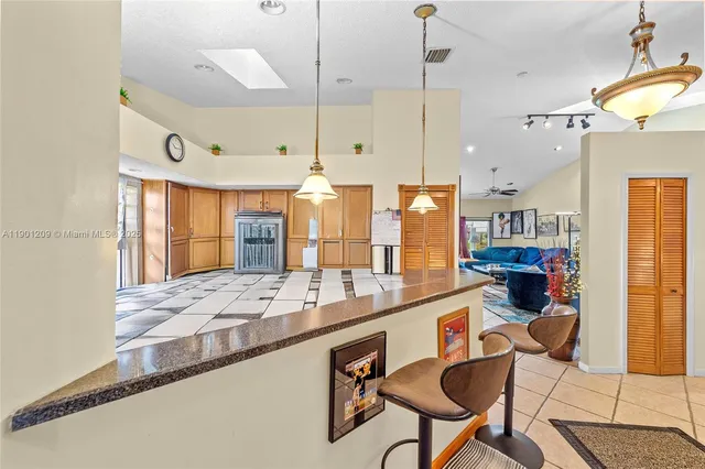 a large kitchen with a lot of counter space and a window