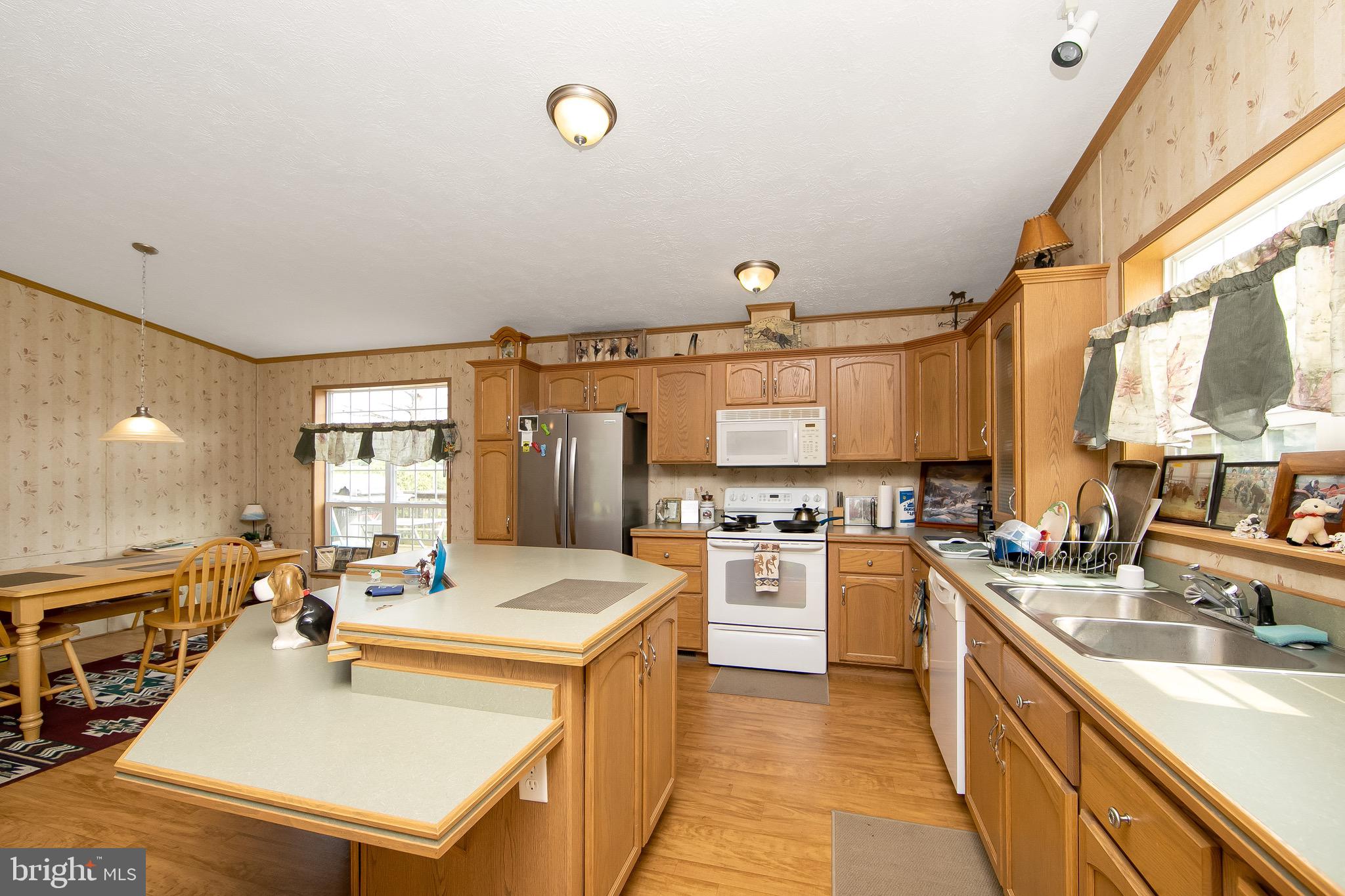 54 Three Bridge Road Monroeville, NJ 08343 - Photo 14 of 35 a large kitchen with kitchen island a sink stove cabinets and wooden floor