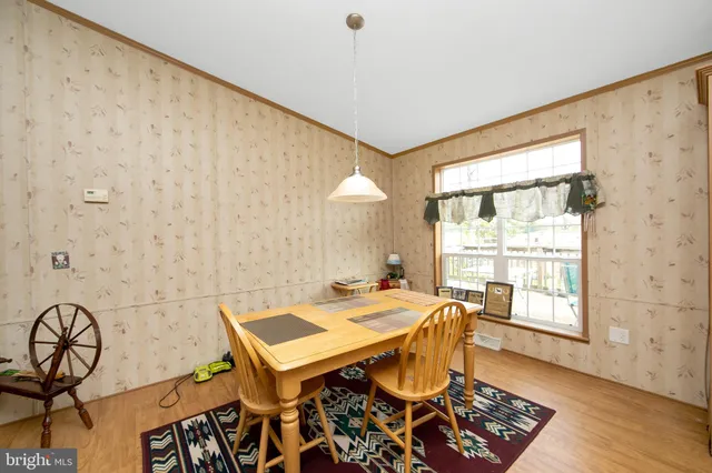 a living room with a table and chairs
