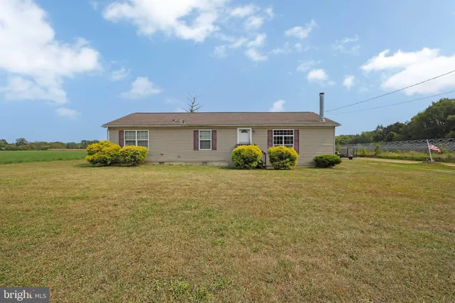 a view of a house with a yard and ocean view