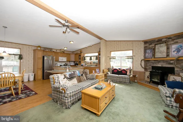 a living room with furniture flat screen tv and a fireplace