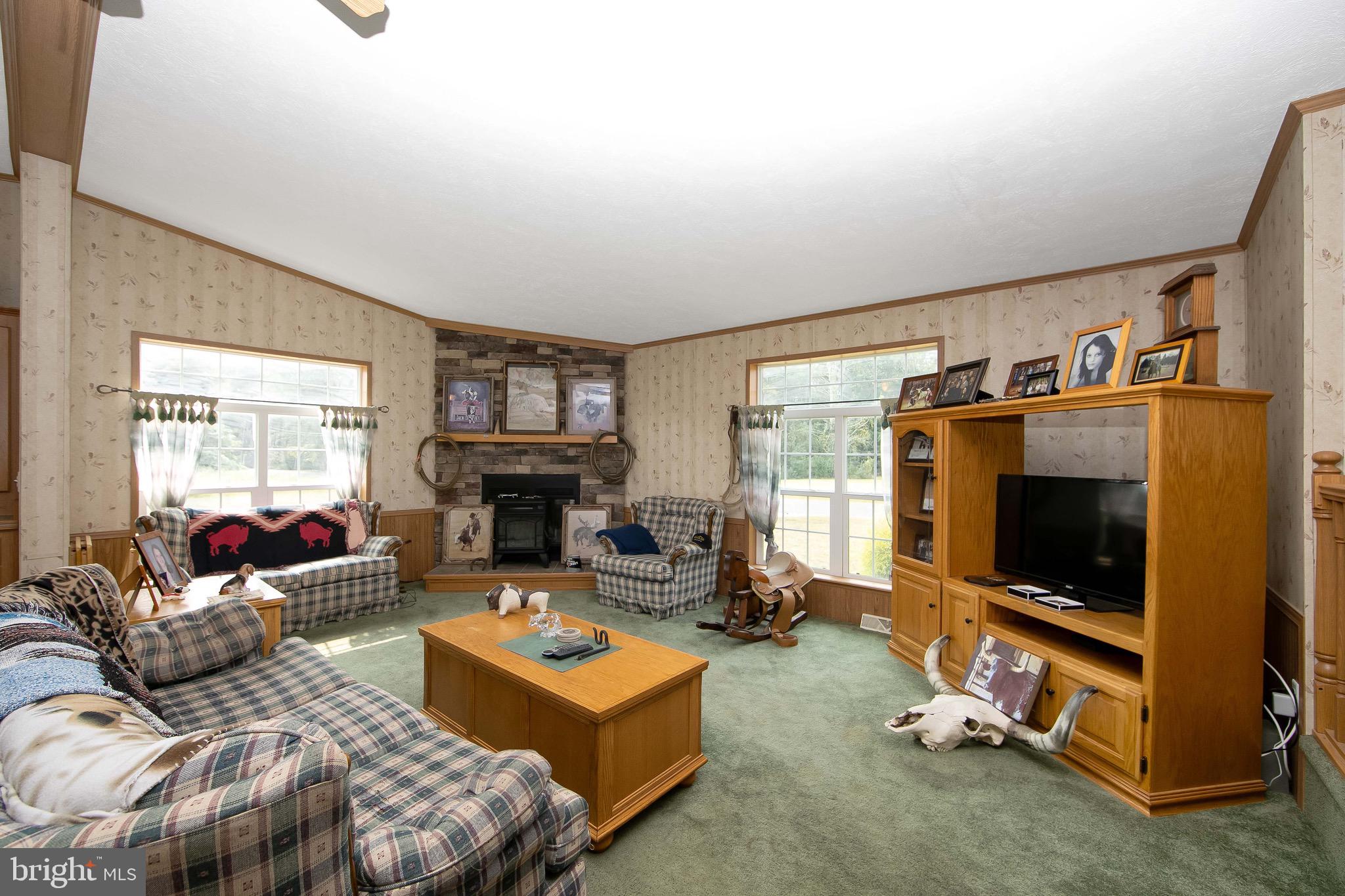 54 Three Bridge Road Monroeville, NJ 08343 - Photo 22 of 35 a living room with furniture flat screen tv and a fireplace