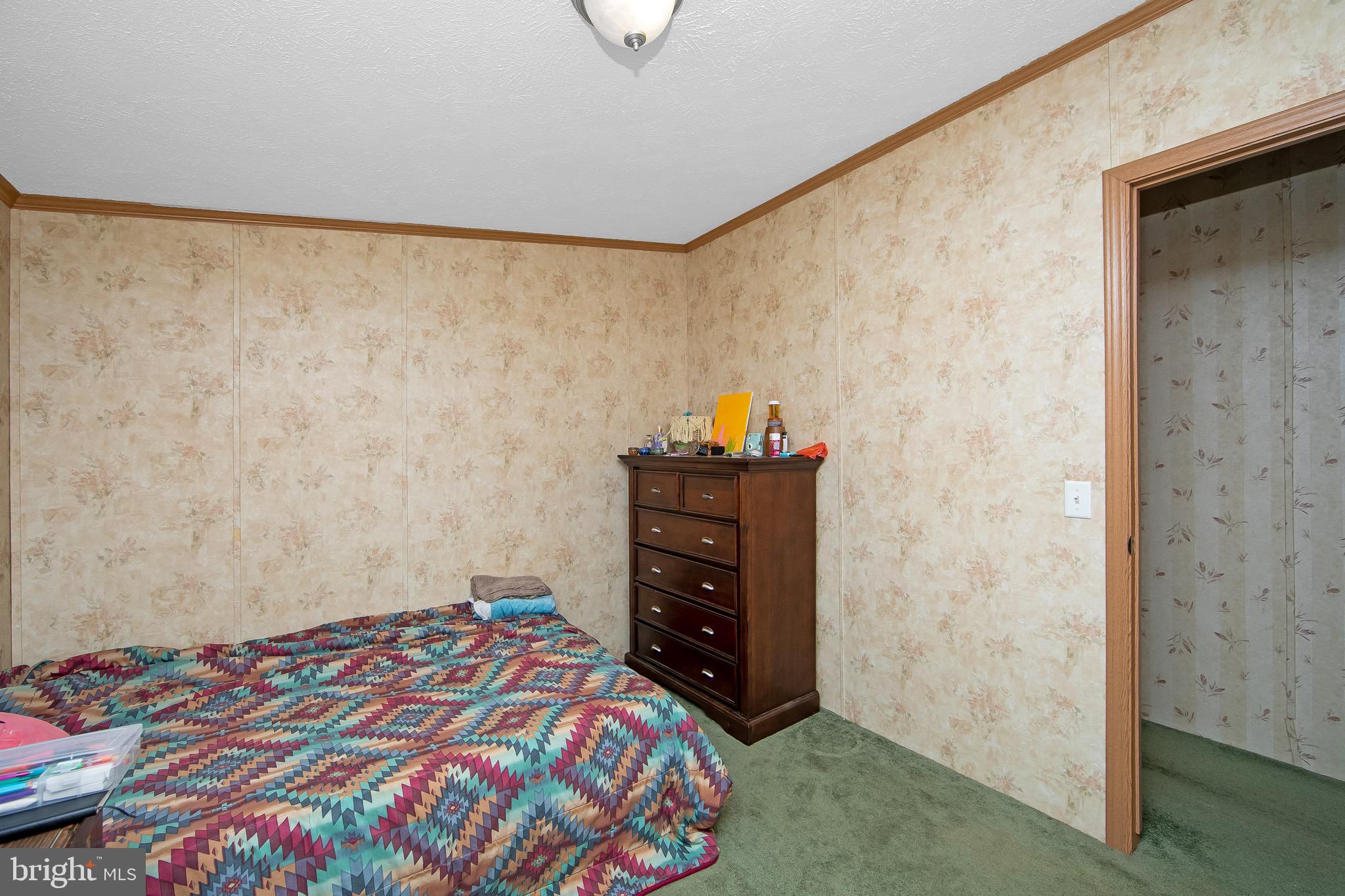 54 Three Bridge Road Monroeville, NJ 08343 - Photo 26 of 35 a bedroom with a bed and a dresser