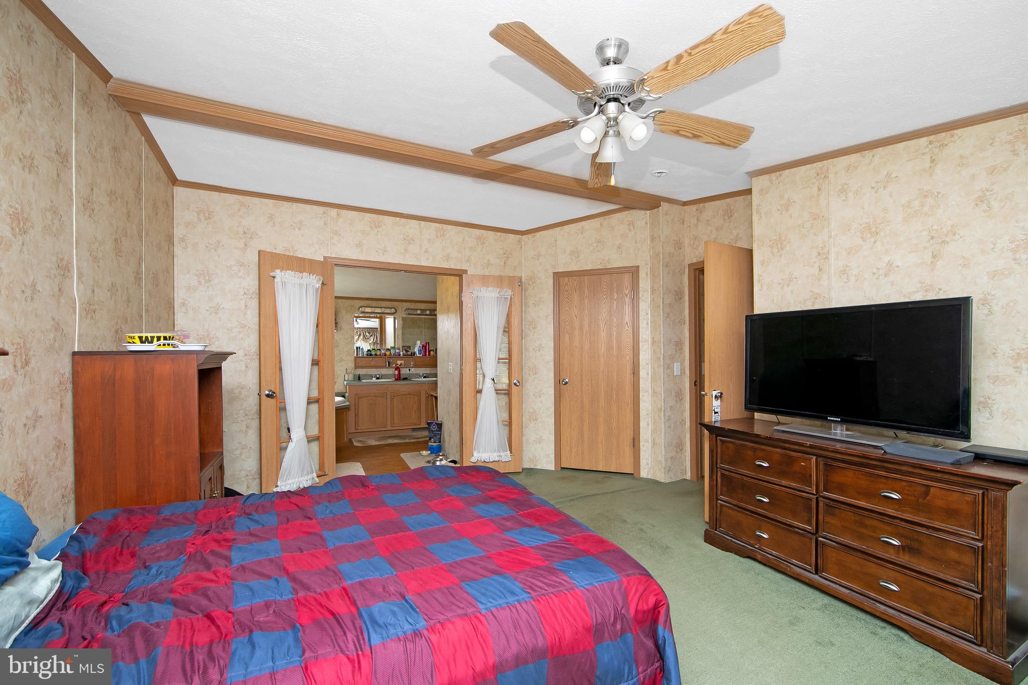 54 Three Bridge Road Monroeville, NJ 08343 - Photo 32 of 35 a bedroom with a bed and a flat screen tv