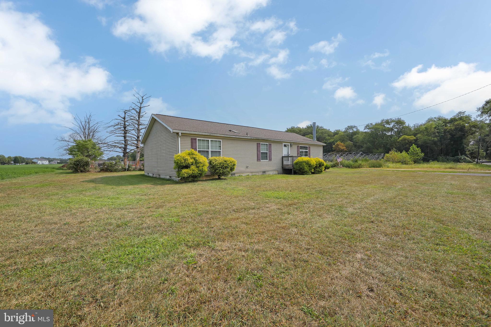 54 Three Bridge Road Monroeville, NJ 08343 - Photo 4 of 35 a front view of a house with a yard