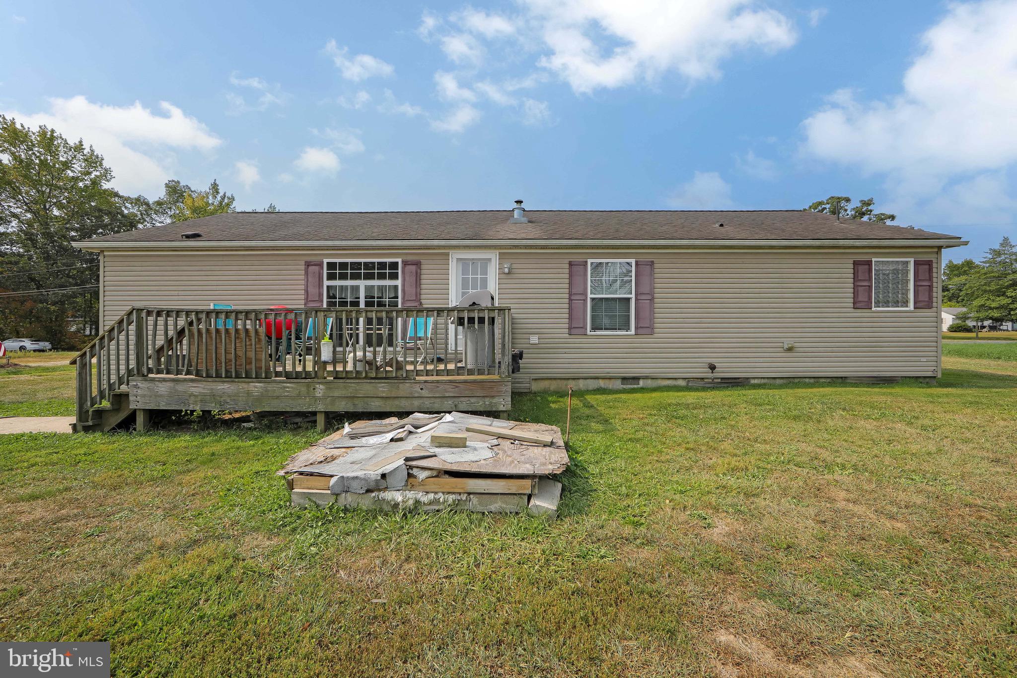 54 Three Bridge Road Monroeville, NJ 08343 - Photo 9 of 35 a backyard of a house with yard table and chairs