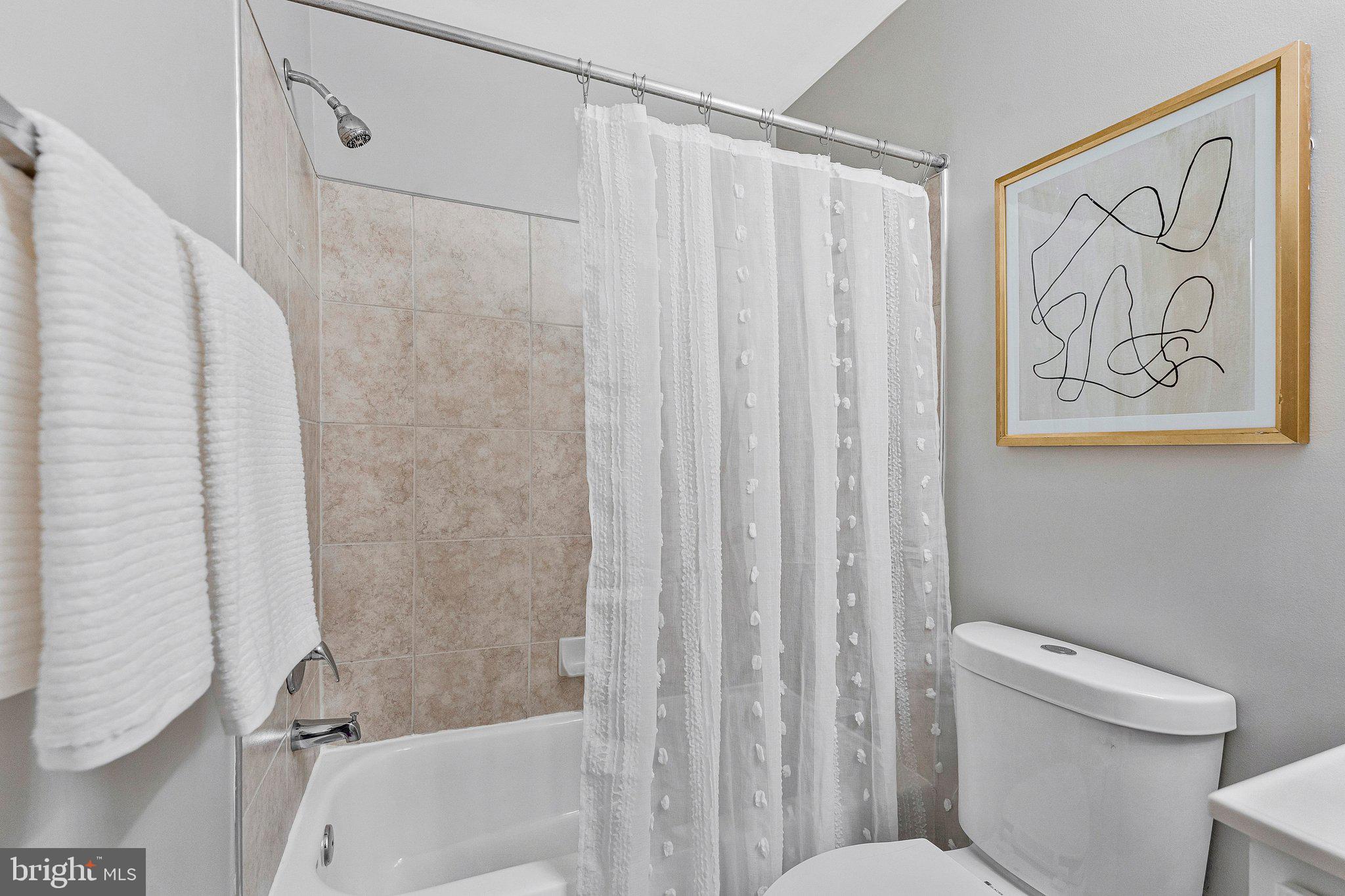 2000 Gallows Tree Lane Vienna, VA 22182 - Photo 36 of 58 a bathroom with a shower curtain and a toilet