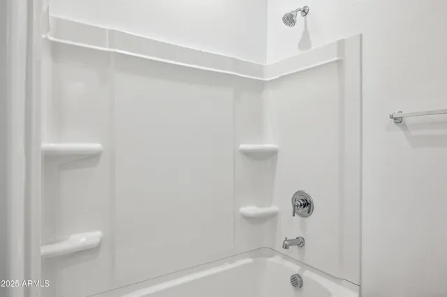 a view of a dining room with furniture and a chandelier