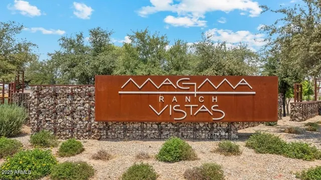 a kitchen with stainless steel appliances kitchen island granite countertop a refrigerator stove top oven and sink