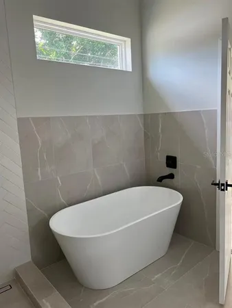 a white bath tub sitting in a bathroom