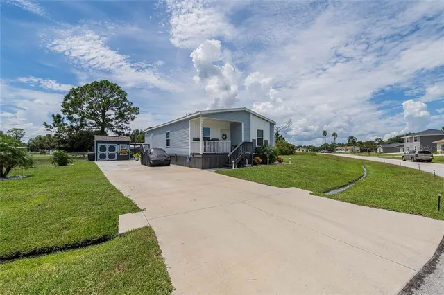 a view of house with yard and green space