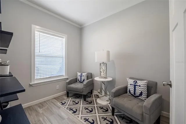 a living room with furniture a window and a flat screen tv