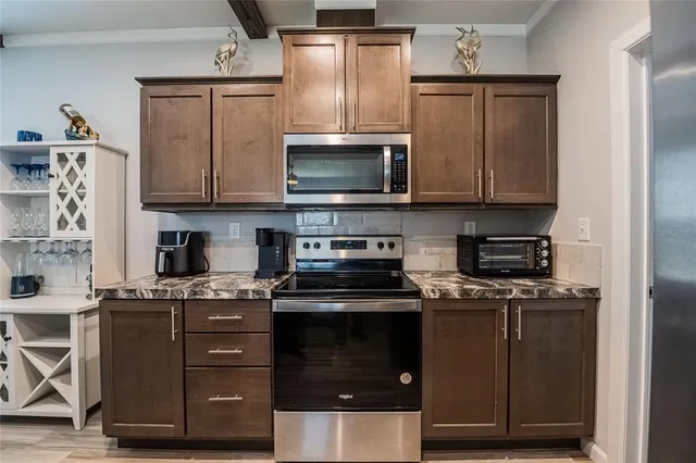 a kitchen with a stove and a microwave