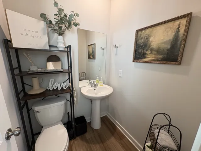 a bathroom with a toilet sink and mirror