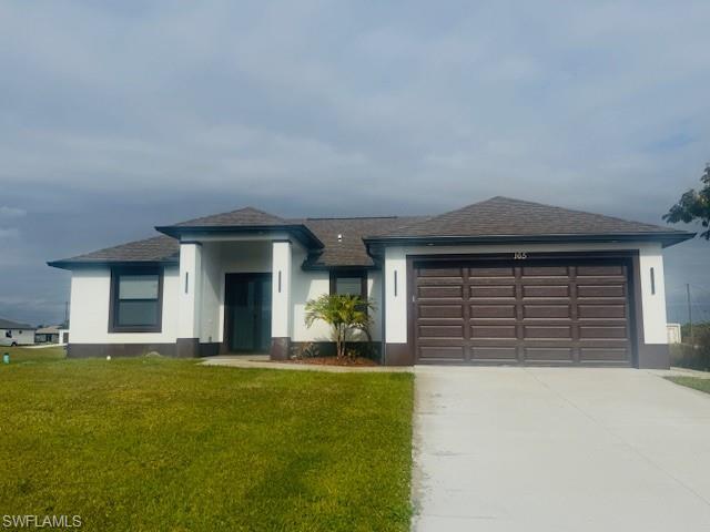 165 Patio Street Lehigh Acres, FL 33974 - Photo 1 of 34 View of front of home with a front lawn, concrete driveway, an attached garage, roof with shingles, and stucco siding