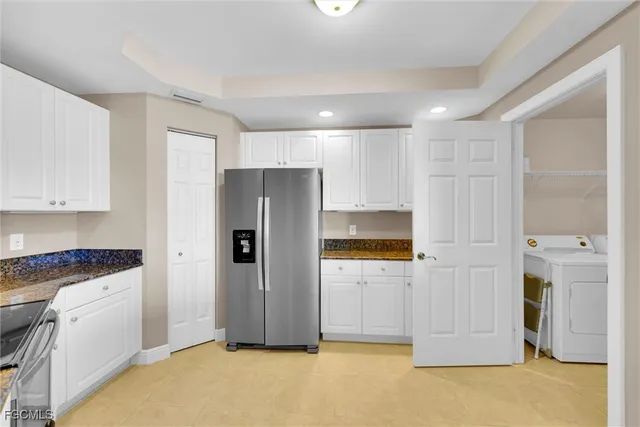 a kitchen with a sink granite counter tops and a window
