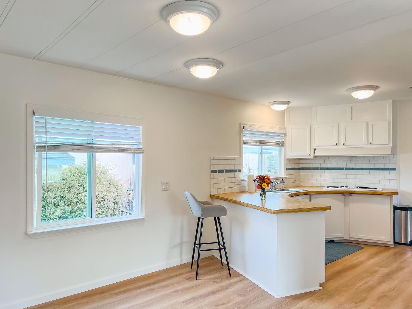 800 Dolan Road, Unit 40 Moss Landing, CA 95039 - Photo 17 of 23 a kitchen with stainless steel appliances granite countertop a stove a sink and a microwave