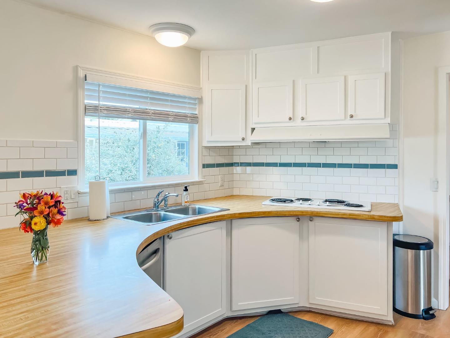 800 Dolan Road, Unit 40 Moss Landing, CA 95039 - Photo 5 of 23 a kitchen with stainless steel appliances granite countertop a sink dishwasher and cabinets with wooden floor