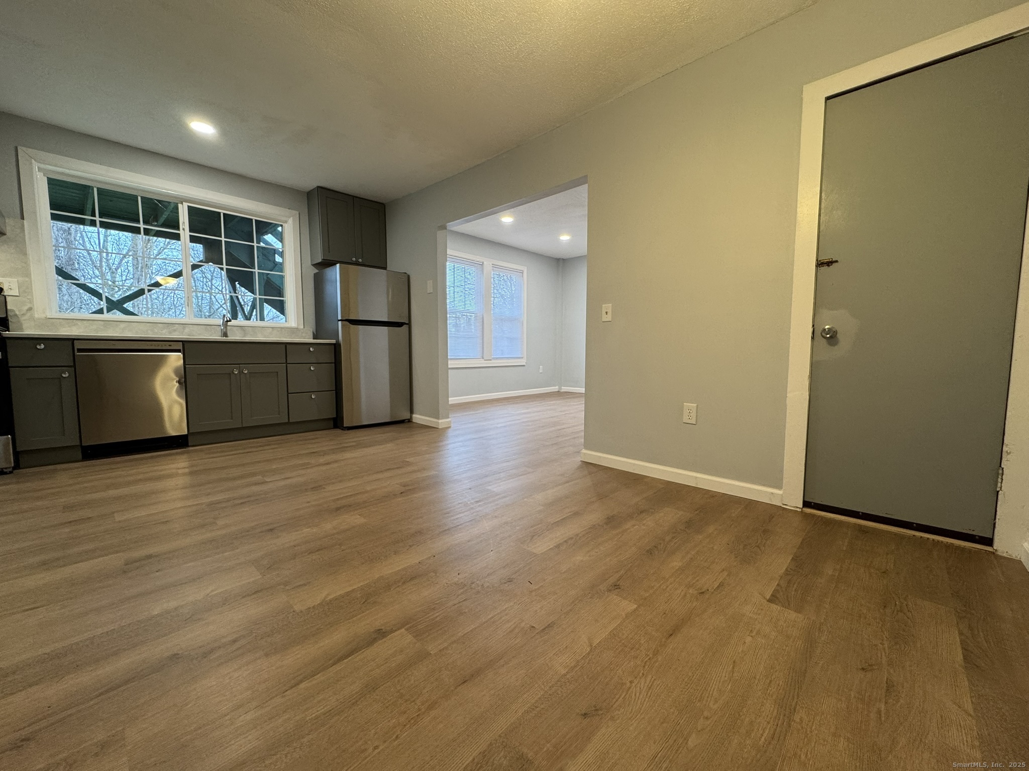 9 South Street, Unit B Cromwell, CT 06416 - Photo 12 of 18 a view of an empty room with wooden floor and a window