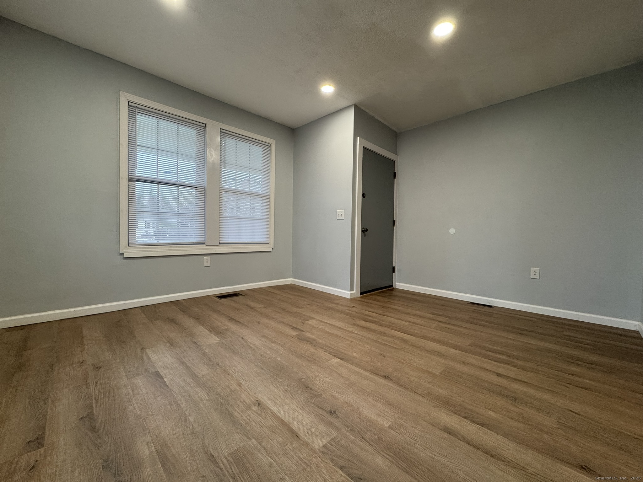 9 South Street, Unit B Cromwell, CT 06416 - Photo 16 of 18 an empty room with wooden floor and windows
