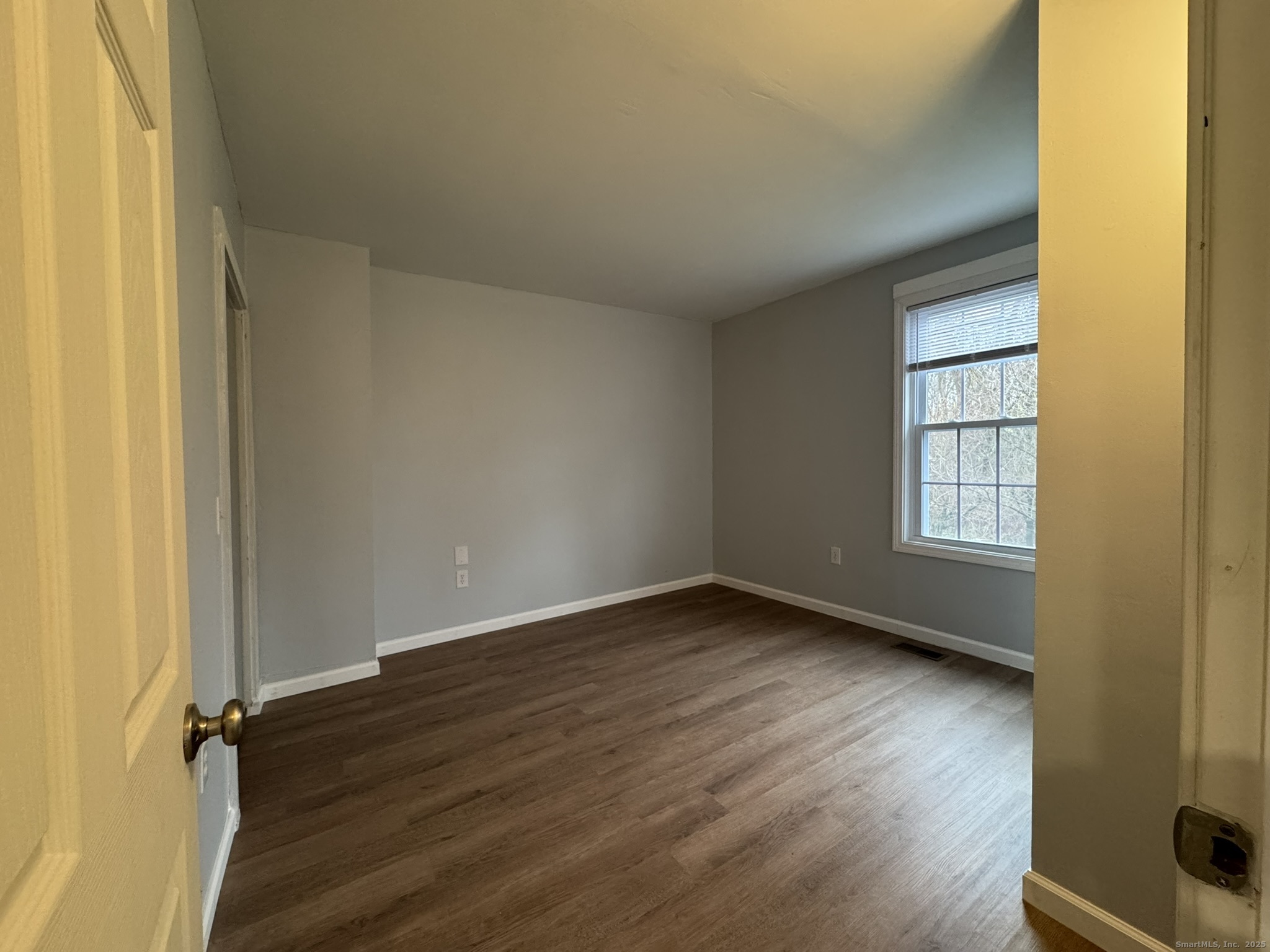 9 South Street, Unit B Cromwell, CT 06416 - Photo 4 of 18 an empty room with wooden floor and windows
