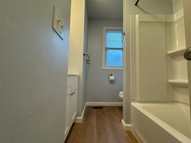 a bathroom with a tub and shower