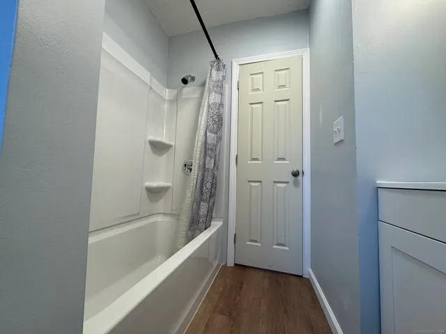 a room with a sink and mirror