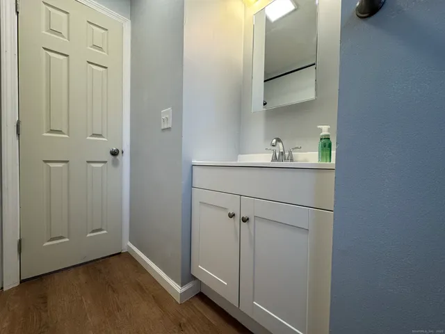 a view of an empty room and a kitchen