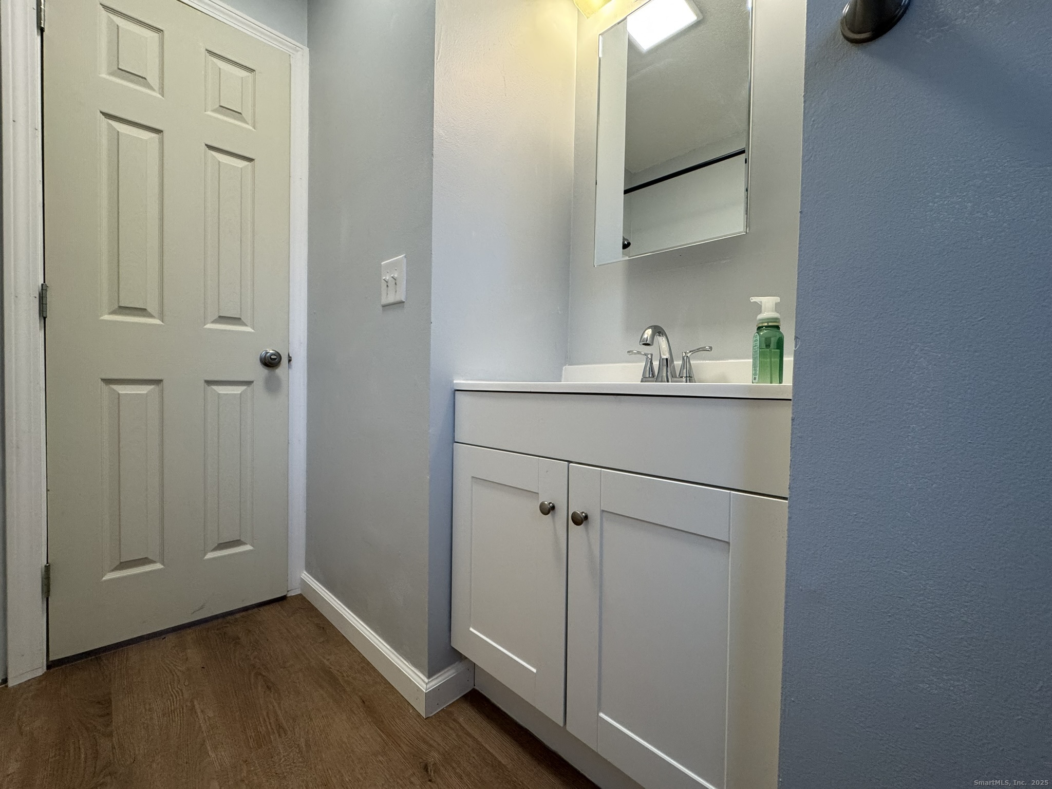 9 South Street, Unit B Cromwell, CT 06416 - Photo 9 of 18 a room with a sink and mirror