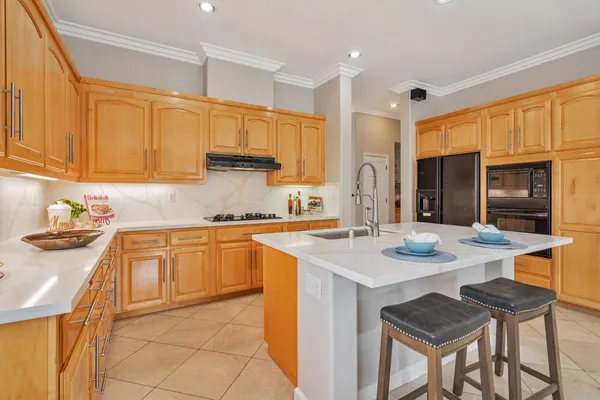 a kitchen with stainless steel appliances granite countertop a sink and cabinets