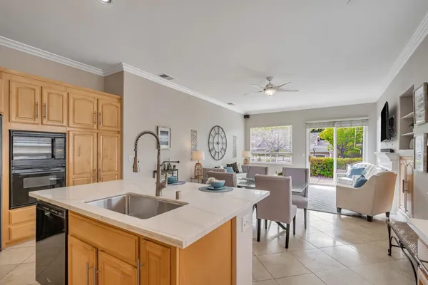 a kitchen with a stove a sink a dining table and chairs
