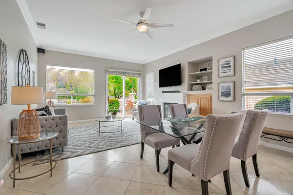a living room with furniture a flat screen tv and a large window