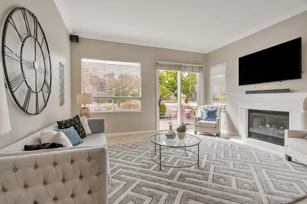 a living room with furniture fireplace and flat screen tv