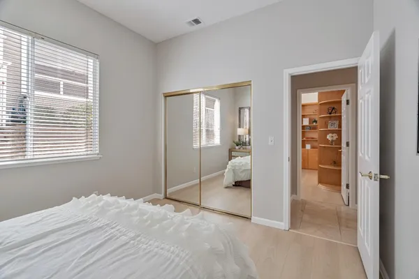 a view of a room with wooden floor and a bathroom