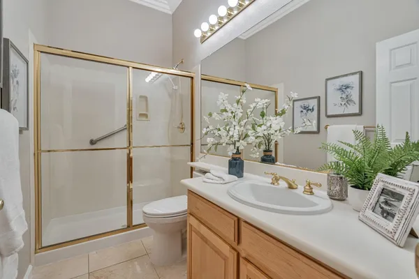 a bathroom with a sink toilet and shower