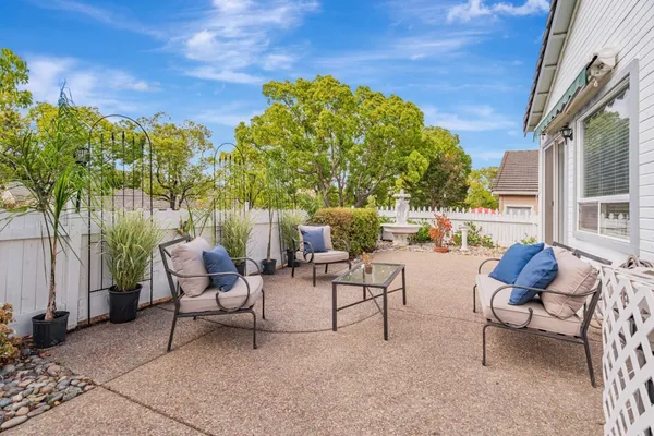 a view of a patio with a table and chairs and couches