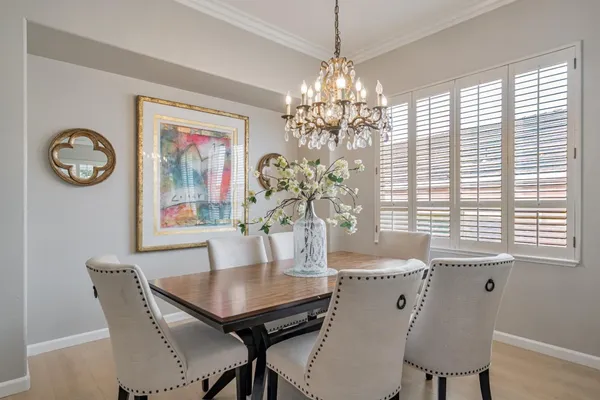 a dining room with furniture a chandelier and window