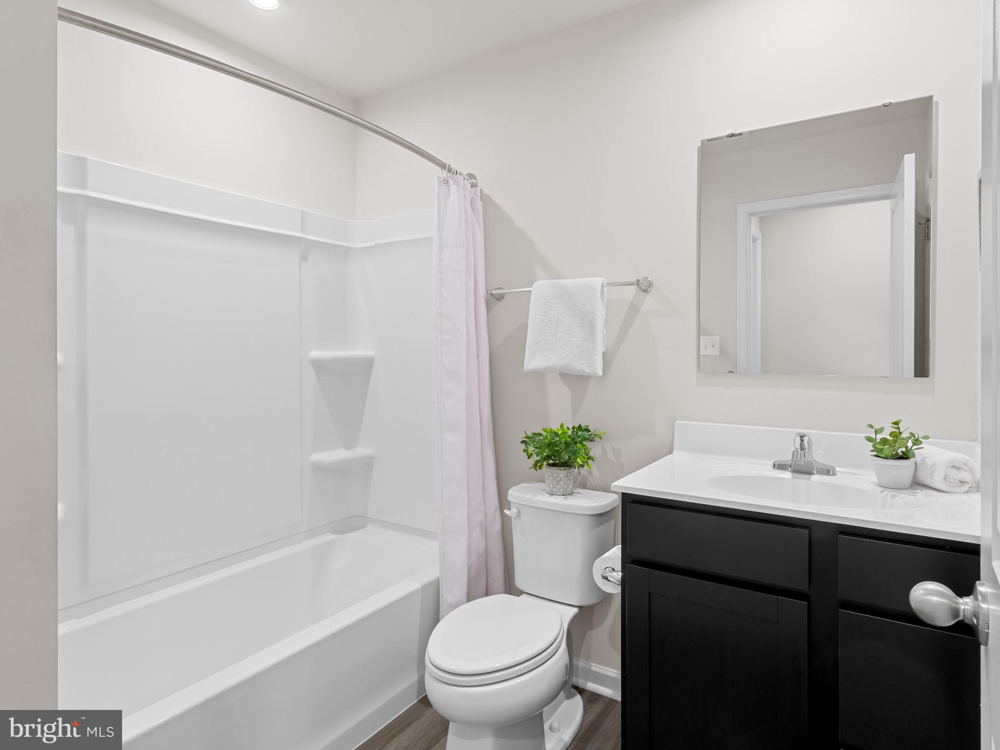 5505 Vergo Road Capitol Heights, MD 20743 - Photo 31 of 42 a bathroom with a sink a toilet a mirror a vanity and shower